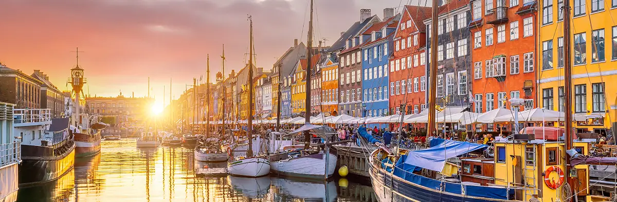 Strada centrale di copenaghen con fiume e case colorate ai lati