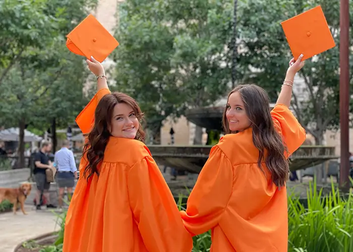 ragazze alla fine del loro anno all'estero che festeggiano il diploma vestite con tunica e cappello